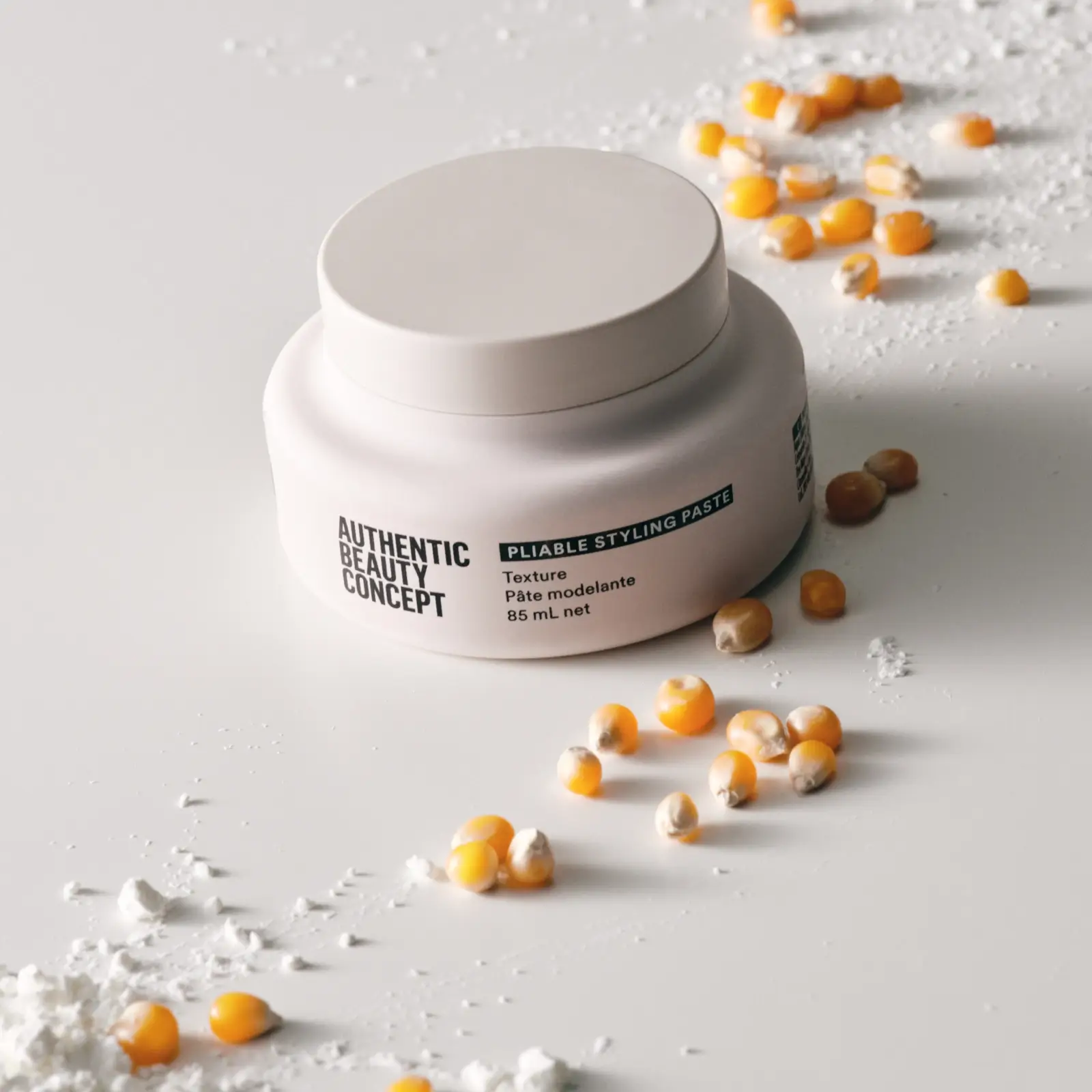 authentic beauty concept pliable styling paste pot displayed with its ingredients of corn starch