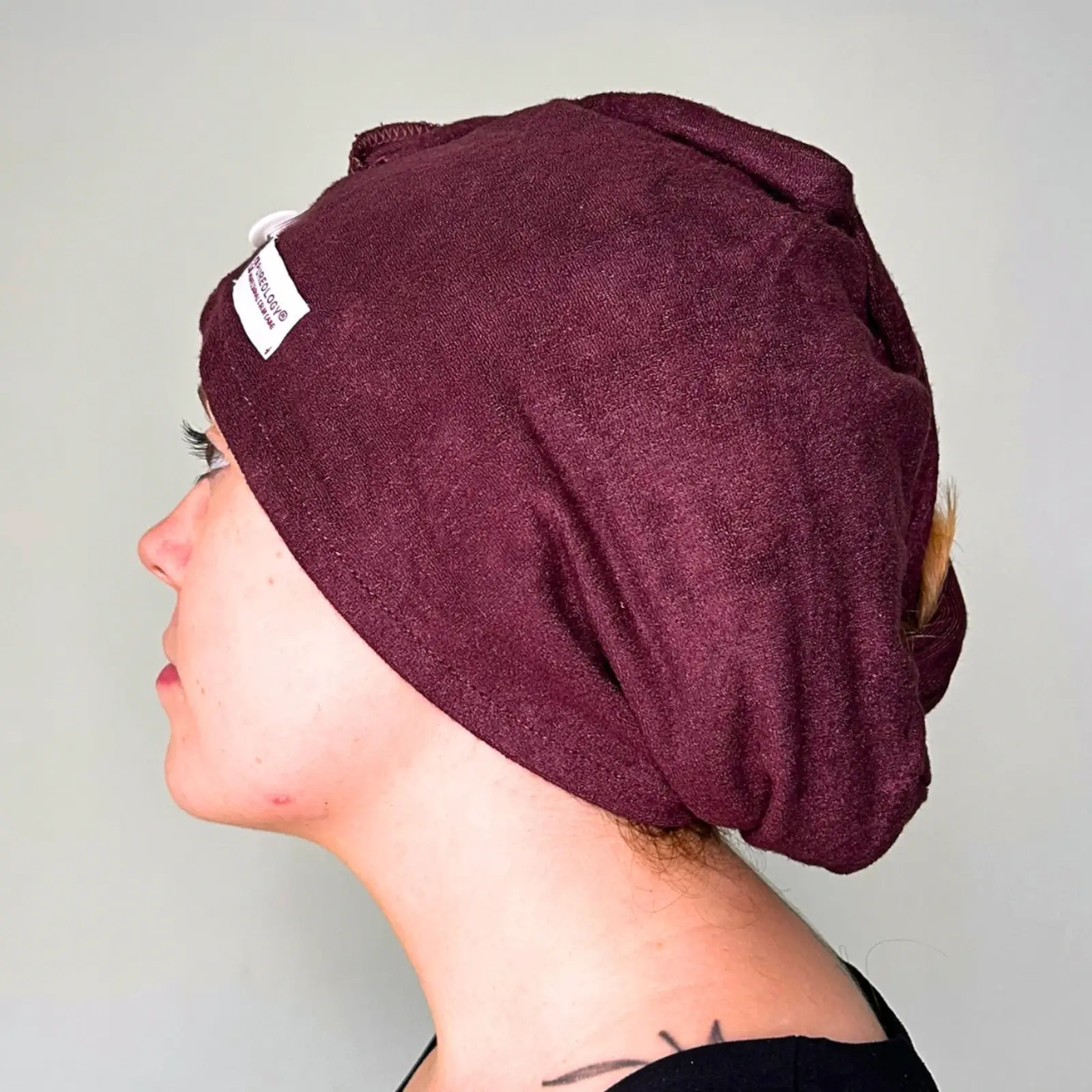 Side view of Pureology Reusable Bamboo Hair Wrap Towel being worn